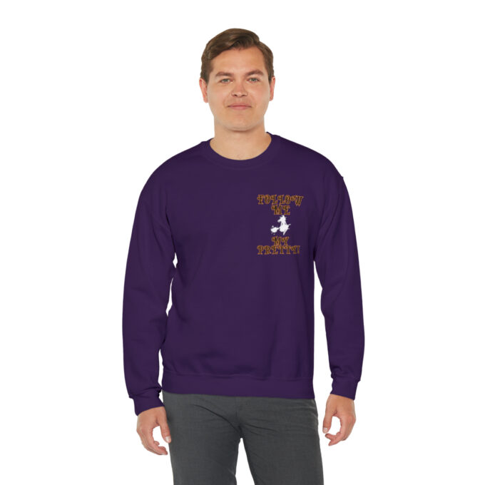 A man in purple sweatshirt with a bird on the front.