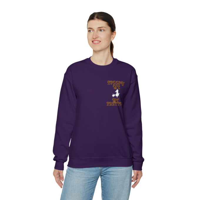 A woman wearing a purple sweatshirt with an image of a person on it.