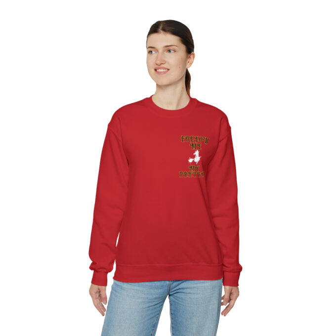 A woman wearing a red sweatshirt with a bird on it.