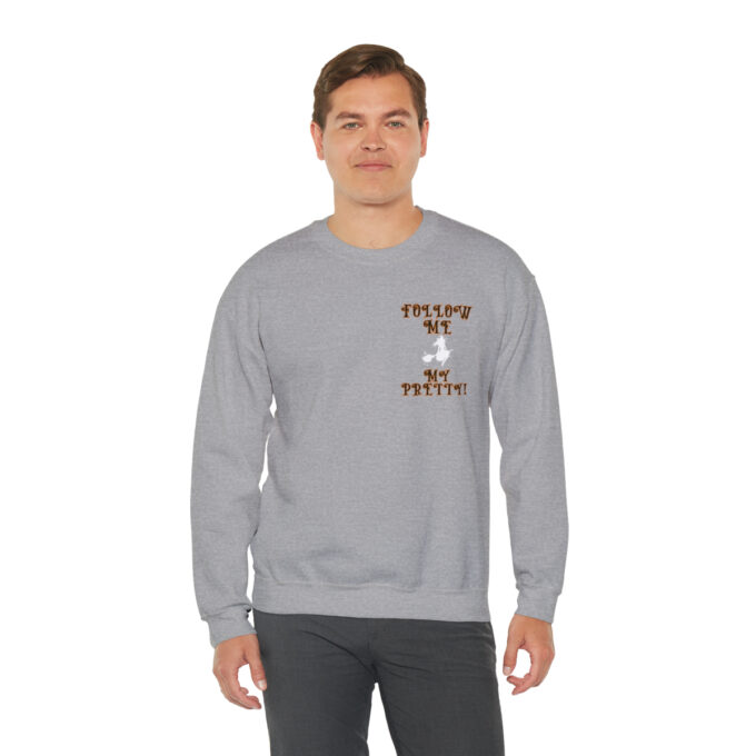 A man wearing a gray sweatshirt with an image of a cat.