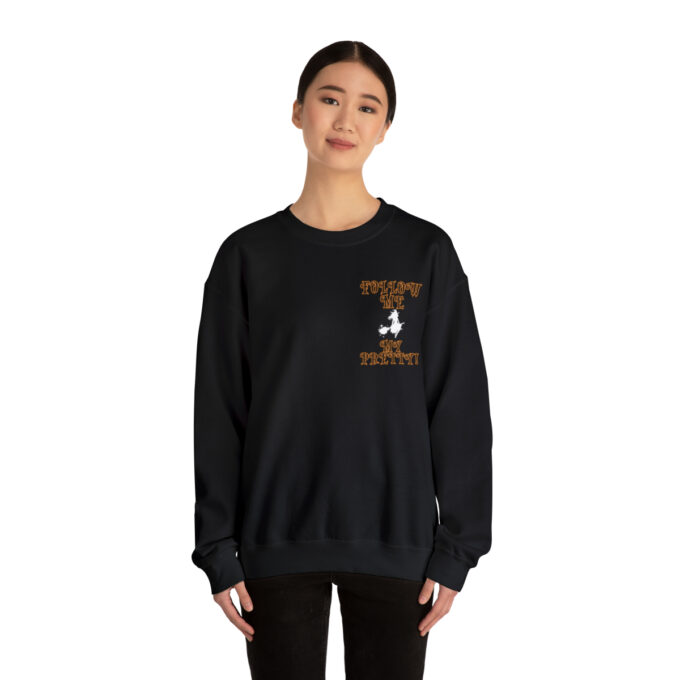 A woman wearing a black sweatshirt with an orange and white design.