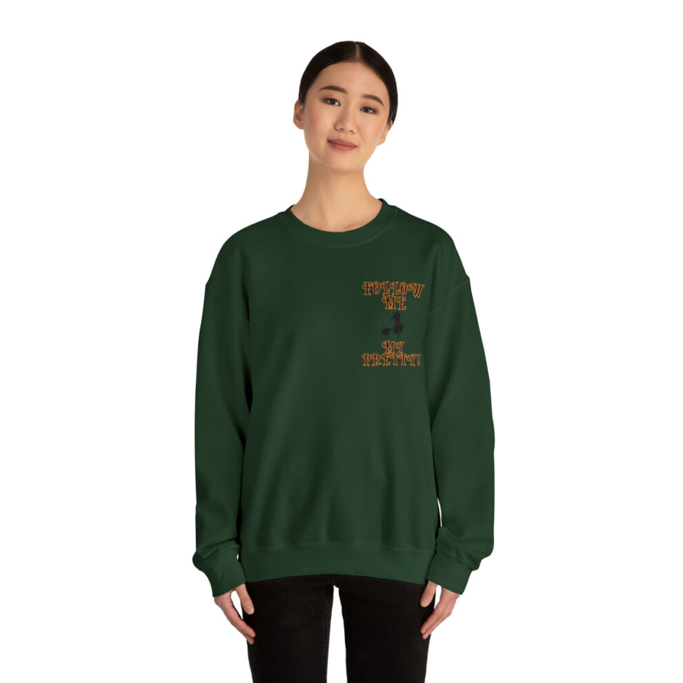 A woman wearing a green sweatshirt with the letter i on it.