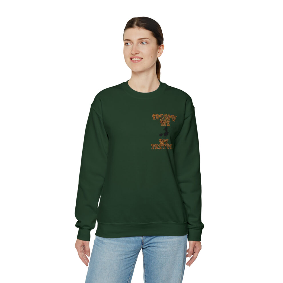 A woman wearing a green sweatshirt with an animal on it.