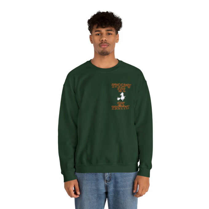 A man in a green sweatshirt is standing up