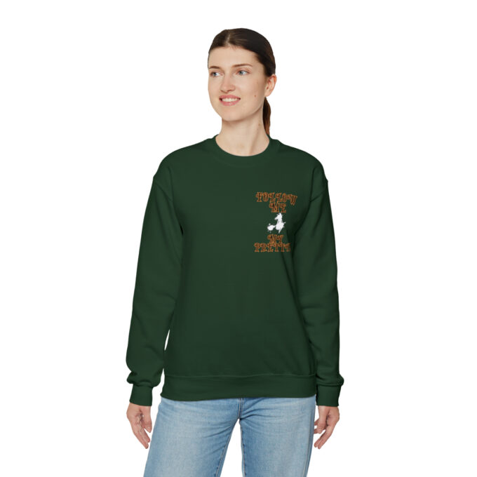 A woman wearing a green sweatshirt with an image of a tree.