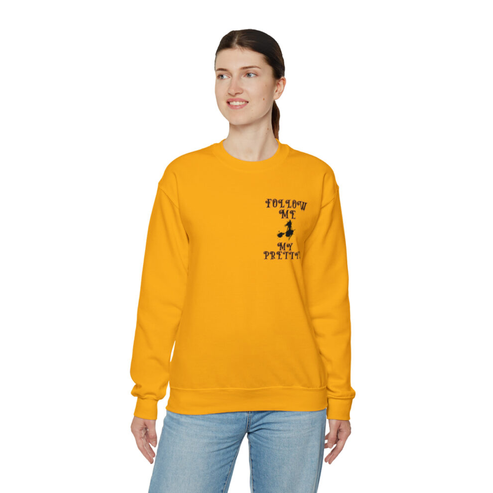 A woman wearing an orange sweatshirt with the words " follow me to college ".