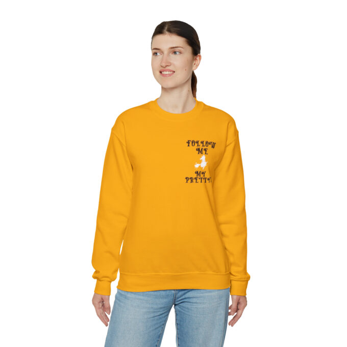 A woman wearing an orange sweatshirt with the words " follow me to pluto ".