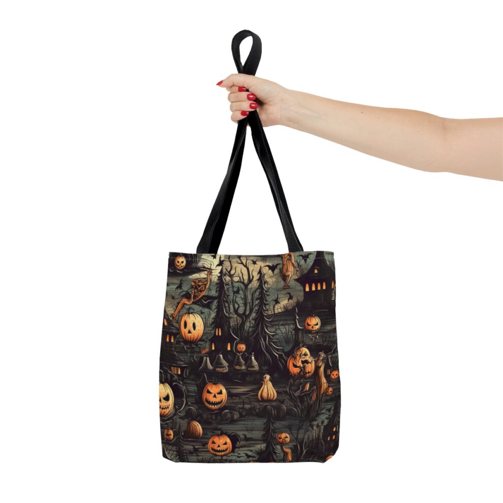 A hand holding up a bag with halloween decorations on it.