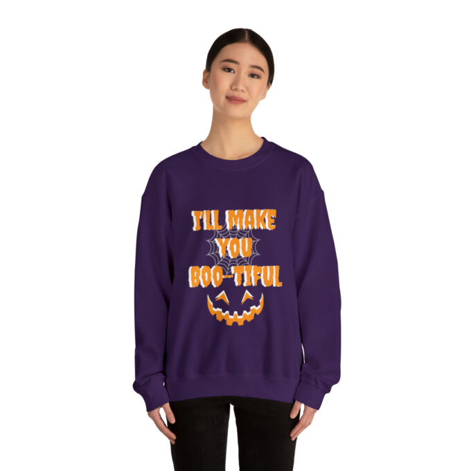 A woman wearing a purple sweatshirt with the words " i 'll have you boo-tiful ".