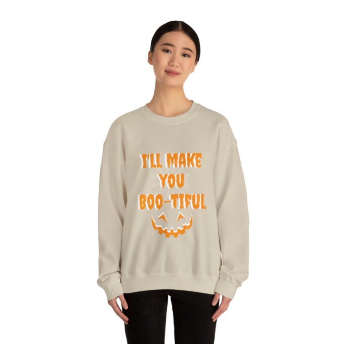 A woman wearing a sweatshirt with the words " i 'll make you boo-tiful ".