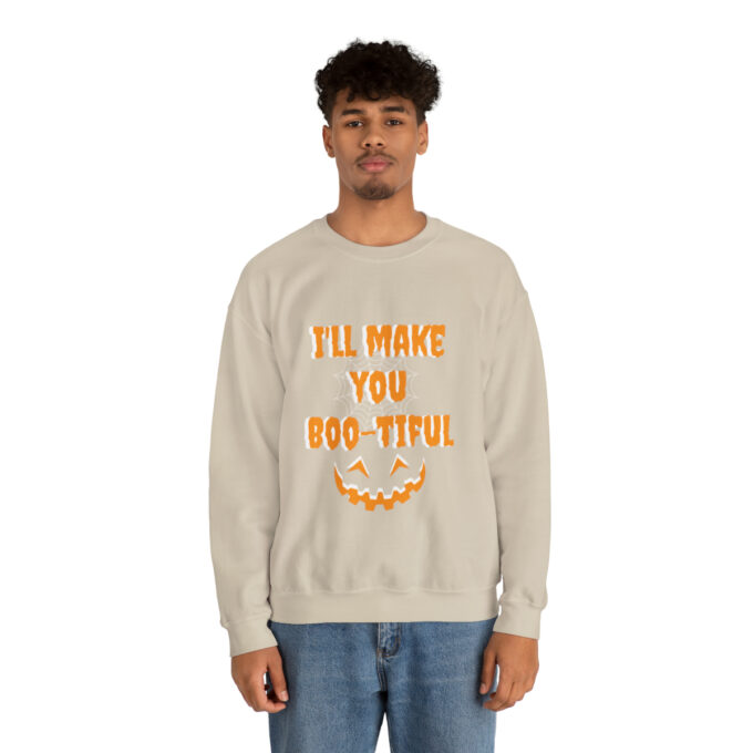 A man wearing an oatmeal colored sweatshirt with the words " i 'll make you boo-tiful ".