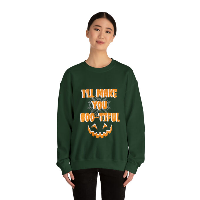 A woman wearing a green sweatshirt with the words " i 'll have you boo-tiful ".