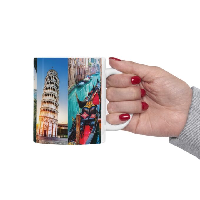 A hand holding a coffee mug with a picture of a building.