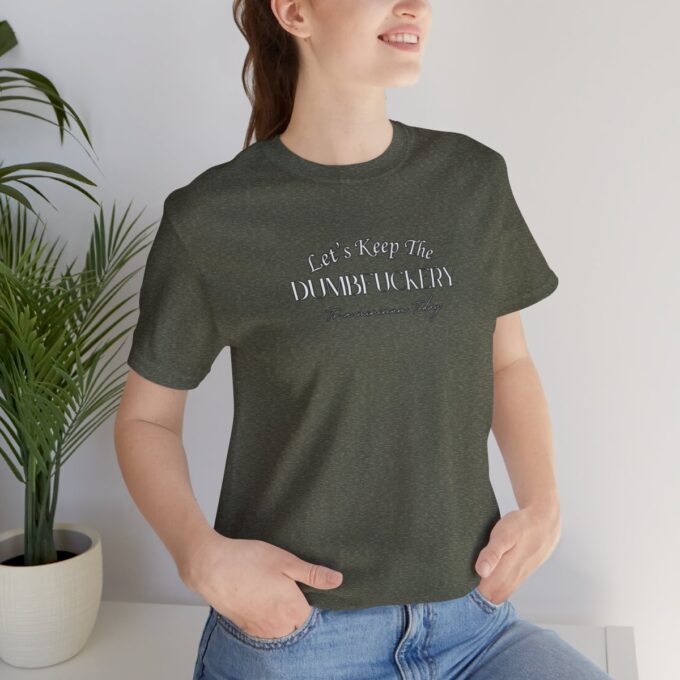 A woman sitting on the ground wearing jeans and a t-shirt.