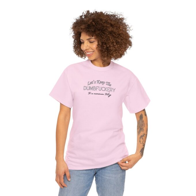 A woman with her hair in an afro is wearing a pink shirt
