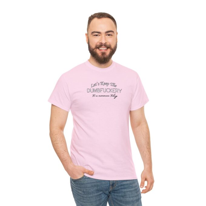 A man wearing a pink t-shirt with the words " i am not perfect but it is someone else."