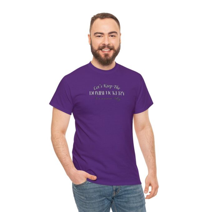 A man with beard and jeans wearing purple t-shirt.