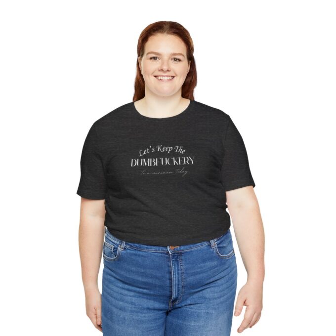 A woman wearing jeans and black t-shirt with words on it.