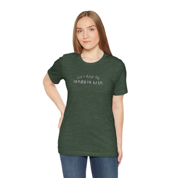 A woman is wearing a green shirt and has her hands on the hips.