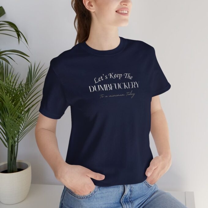 A woman sitting on the ground wearing jeans and a t-shirt.