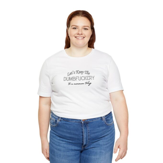 A woman wearing jeans and white shirt with text.
