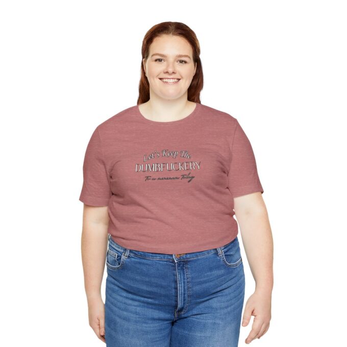 A woman wearing jeans and a t-shirt with the words " strong women are beautiful ".