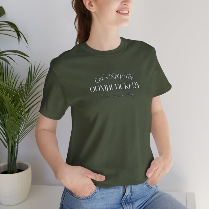 A woman sitting on the ground wearing jeans and a t-shirt.